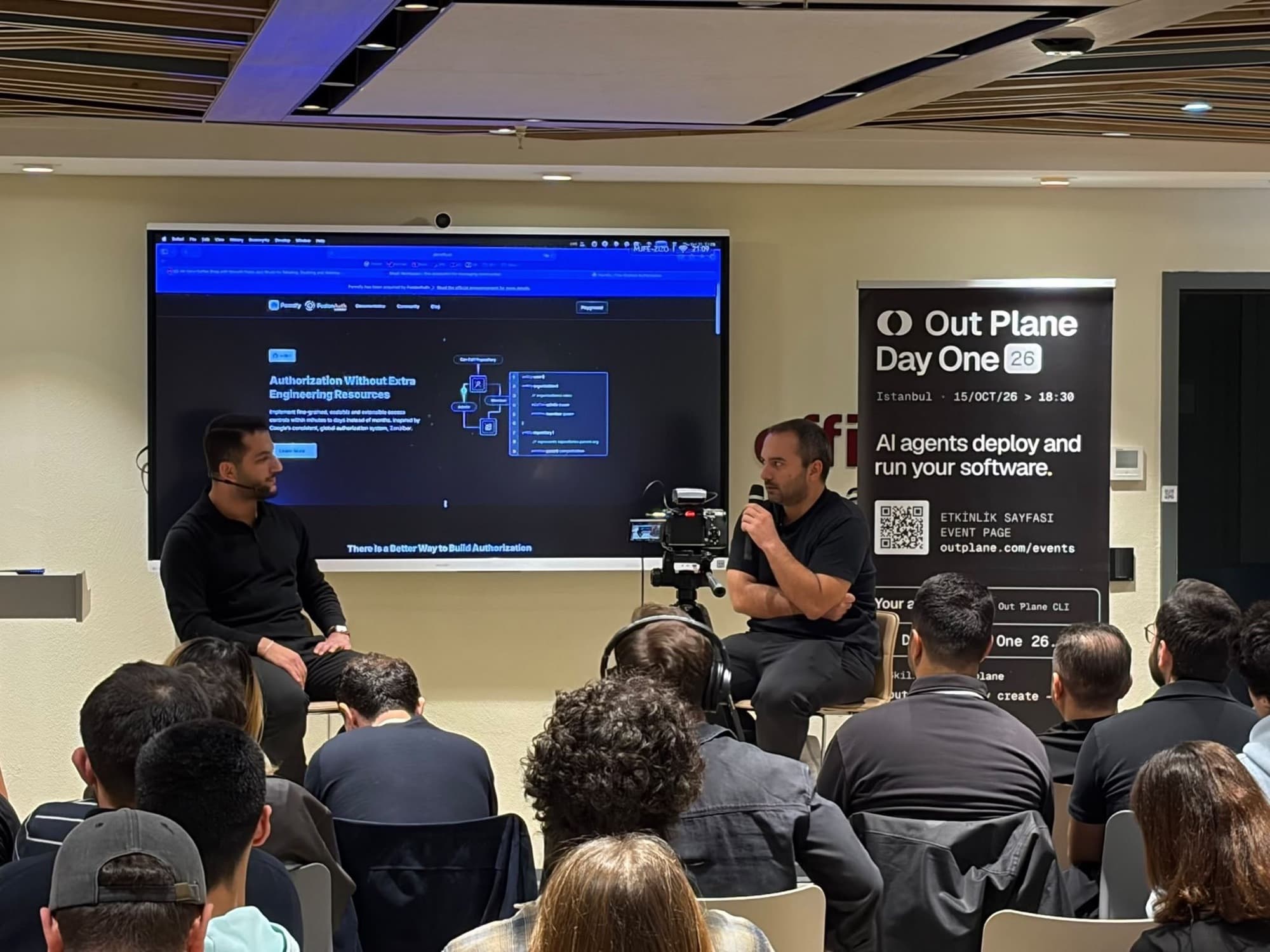 Fireside chat on stage in front of a full room