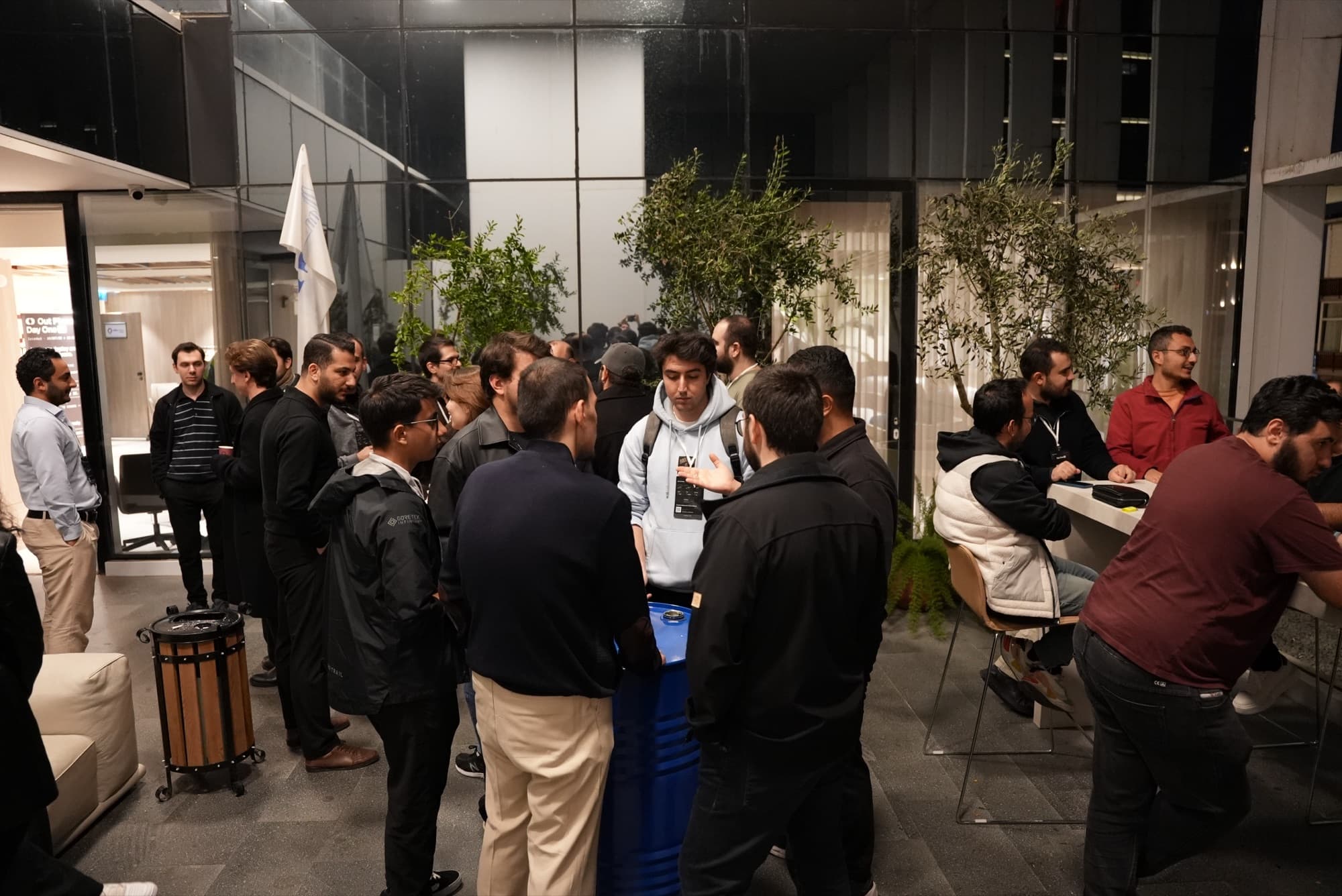 Attendees networking in the courtyard at night