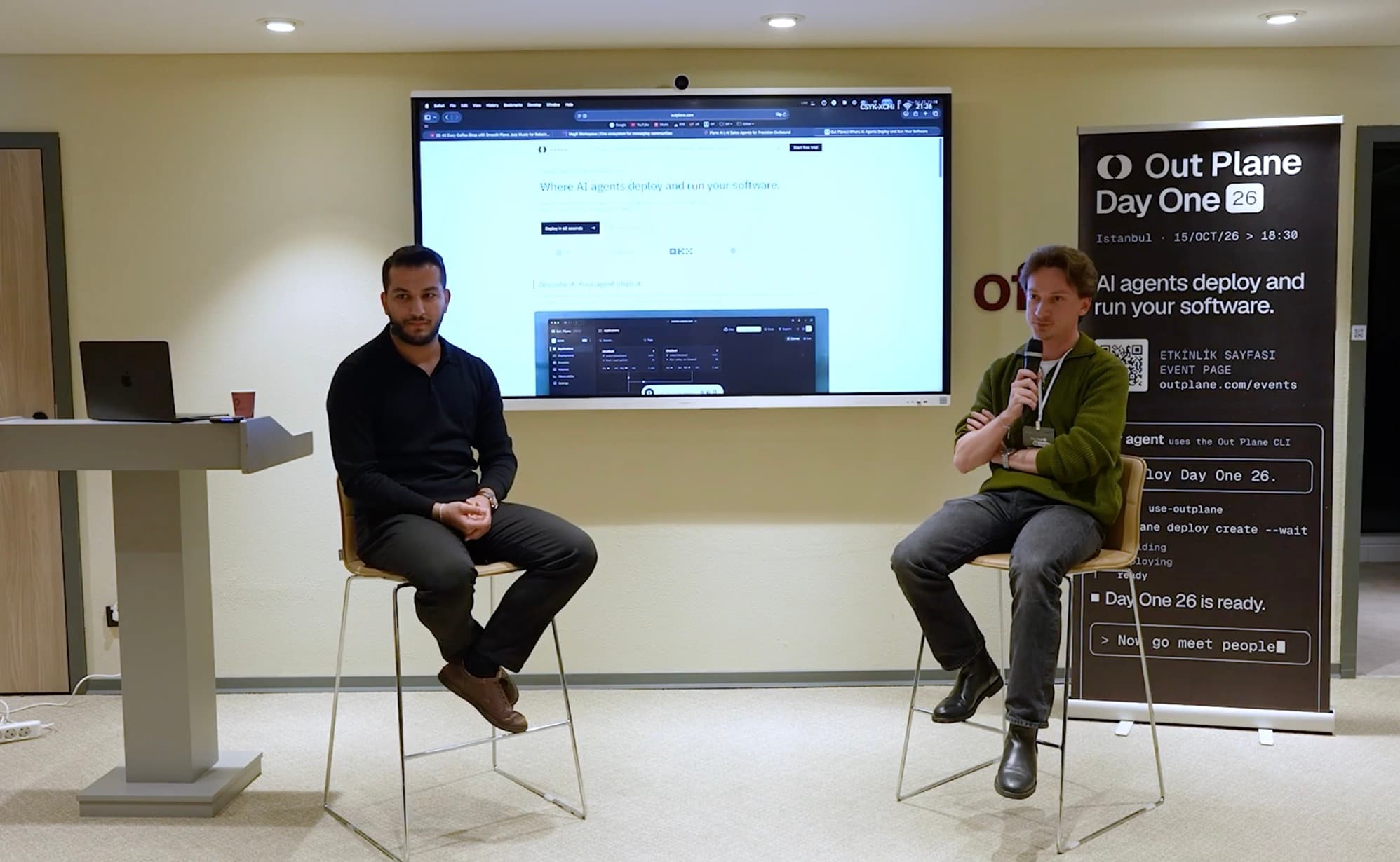 Fireside session on stage with the Out Plane site on screen
